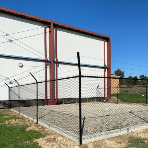 Perimeter fence beside building Perimeter fence beside building